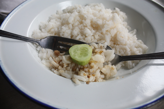 A bite of rice and nam prik with cucumber
