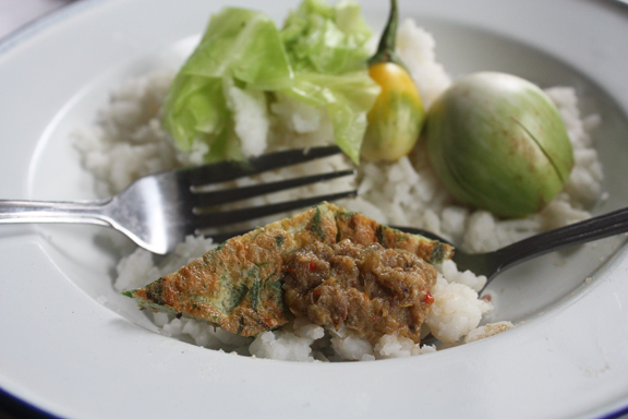 Nam prik eaten with a piece of cha-om omelet